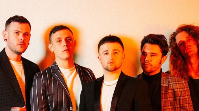 5 men posing in warm lighting